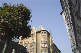 Budapest, Pest County, Hungary. Street scene with part view of Empire era apartment blocks with