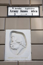 Budapest, Pest County, Hungary. Street sign and relief portrait of Janos Arany 1817 to 1882 the
