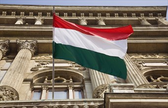Budapest, Pest County, Hungary. Hungarian flag flying from building facade. Hungary Hungarian