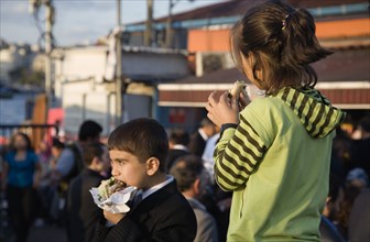 Istanbul, Turkey. Sultanahmet. Turkish boy and girl eating grilled fresh fish in bread at Kumkapi