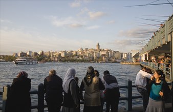 Istanbul, Turkey. Sultanahmet. Crowd leaning on railings beside the Bosphorus admiring view to