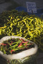 Kusadasi, Aydin Province, Turkey. Red and green chilies for sale on stall at weekly market. Turkey