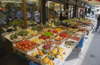 Vienna, Austria. The Naschmarkt. Display of fresh fruit and vegetables for sale outside shopfront.