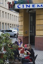 Vienna, Austria. People seated at Cafe tables on pavement outside cinema. Austria Austrian Republic