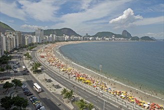 Rio de Janeiro, Brazil. Copacabana. The full sweep of Avenue Atlantica mosiac sidewalk with crowds