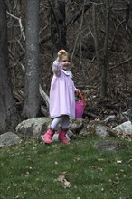 Young girl Sarah Bleau taking part in Easter egg hunt in Keene New Hampshire. Festival Festivals