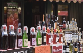 Vienna, Austria. The Naschmarkt. Display of Federweisser wine in the fermentation stage known as