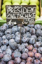 Vienna, Austria. The Naschmarkt. Fresh plums for sale on market fruit stall display. Austria