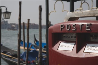 Venice, Veneto, Italy. Post box with gondolas moored on the Grand Canal behind. Italy Italia