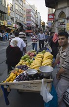 Istanbul, Turkey. Sultanahmet. Fresh fruit stall beside tramway on busy street. Turkey Turkish