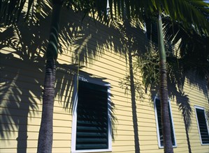 Key West, Florida, USA. Detail of shuttered wooden building with palm trees Clapperboard American