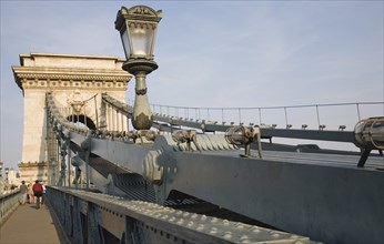 Budapest, Pest County, Hungary. Tourists crossing Szechenyi Chain Bridge or Memory Bridge on foot