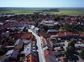 Denmark, Jutland, Ribe, View south-west over city rooftops and cobbled street towards farmland from
