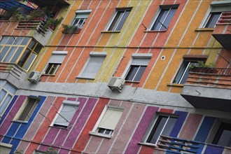 Albania, Tirane, Tirana, Angled part view of exterior facade of apartment block painted in brightly