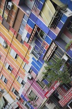 Albania, Tirane, Tirana, Angled part view of apartment block painted in brightly coloured stripes