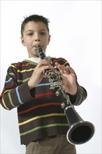 Music, Instrument, Woodwind, A schoolboy playing the clarinet. Cropped to three-quarter view facing