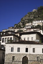 Albania, Berat, Traditional white painted Ottoman houses with tiled rooftops on hillside in the old
