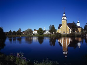 Finland, Vaasanlaani, Nykarle, Village church beside the River Lapuanjoki.  Cream and white painted