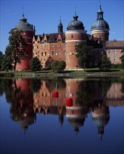 Sweden, Sodermanland, Mariefred, Gripsholm Castle beside Lake Malaren.  Red brick exterior with