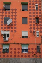 Albania, Tirane, Tirana, Detail of exterior facade of apartment block painted orange with pattern