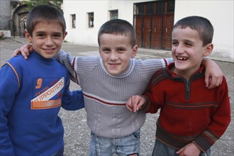 Albania, Berat, Three smiling young boys.