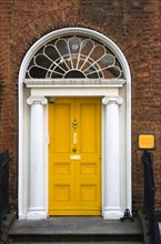 Ireland, County Dublin, Dublin City, Yellow Georgian door in the city centre south of the Liffey
