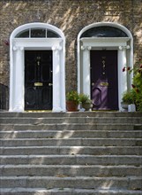 Ireland, County Dublin, Dublin City, Black and purple Georgian doors at the top of steps in the