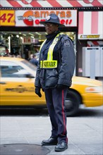 USA, New York, New York City, Manhattan  Times Square Public Safety Officer in uniform on patrol in