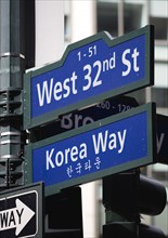 USA, New York, New York City, Manhattan  Street signs for West 32nd Street also known as Korea Way