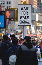 USA, New York, New York City, Manhattan  People in Times Square by pedestrian crossing sign with a