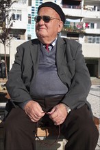 Albania, Tirane, Tirana, Three-quarter portrait of an elderly man wearing black beret and