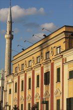 Albania, Tirane, Tirana, Part view of exterior facade of government buildings and minaret of Ethem