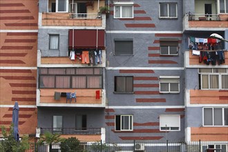 Albania, Tirane, Tirana, Part view of exterior facade of colourful apartment building with washing