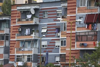 Albania, Tirane, Tirana, Part view of exterior facade of colourful apartment building with washing