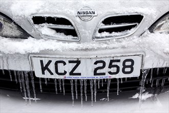 Weather, Winter, Ice, Melting snow and icicles on car fender and grill.