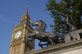 England, London, Westminster, Angled view looking up at Big Ben clock tower with the Boadicea