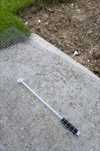 Climate, Weather, Measurements, Thermometer beneath protective wire mesh laid on concrete to