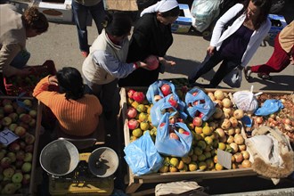 Albania, Tirane, Tirana, Looking down on stall of street vendor selling apples  pomegranates and
