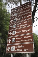 Albania, Kruja, Bi-lingual road sign giving direction to places of interest in Kruja.