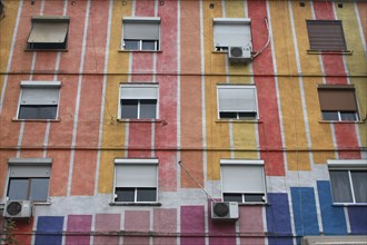 Albania, Tirane, Tirana, Part view of exterior facade of striped  multi-coloured apartment building