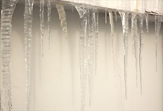Weather, Winter, Ice, Large Icicles hanging from roof eaves.