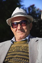 Albania, Tirane, Tirana, Head and shoulders full face portrait of a middle-aged man wearing a hat