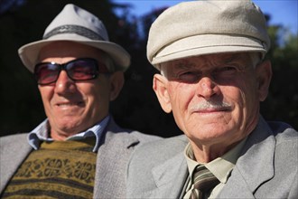 Albania, Tirane, Tirana, Head and shoulders portrait of two men. One elderly looking straight to
