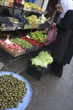 Albania, Tirane, Tirana, Female customers at fruit and vegetable stall in the Avni Rustemi market