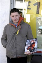 England, Oxfordshire, Thame, A young man selling the Big Issue in Thame in the UK.