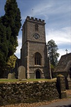 England, Devon, General, Church clock tower and entrance seen from graveyard