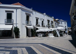 Portugal, Algarve, Faro, Main shopping area with white washed buildings and colourfully decorated