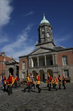 Ireland, Dublin, Performers wearing jester cotumes dancing in the Upper Yard of Dublin Castle