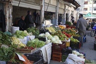 Albania, Tirane, Tirana, Customer and vendors at fruit and vegetable stalls in the Avni Rustemi
