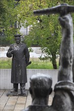 Albania, Tirane, Tirane, Statue of Stalin standing opposite another statue of figure standing with